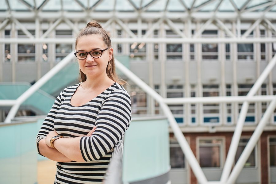 Woman with arms crossed smiling at camera