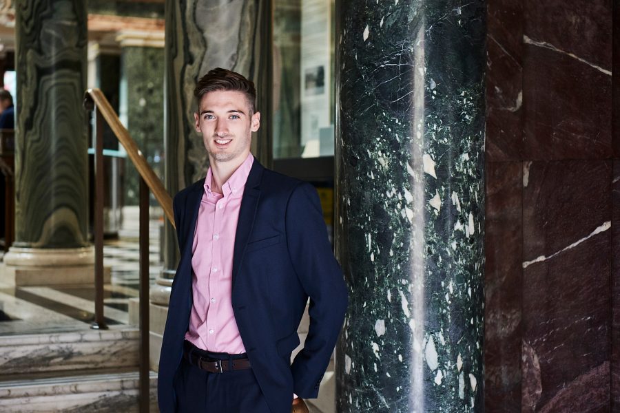 Man smiling to camera in the Marble Hall, Norwich