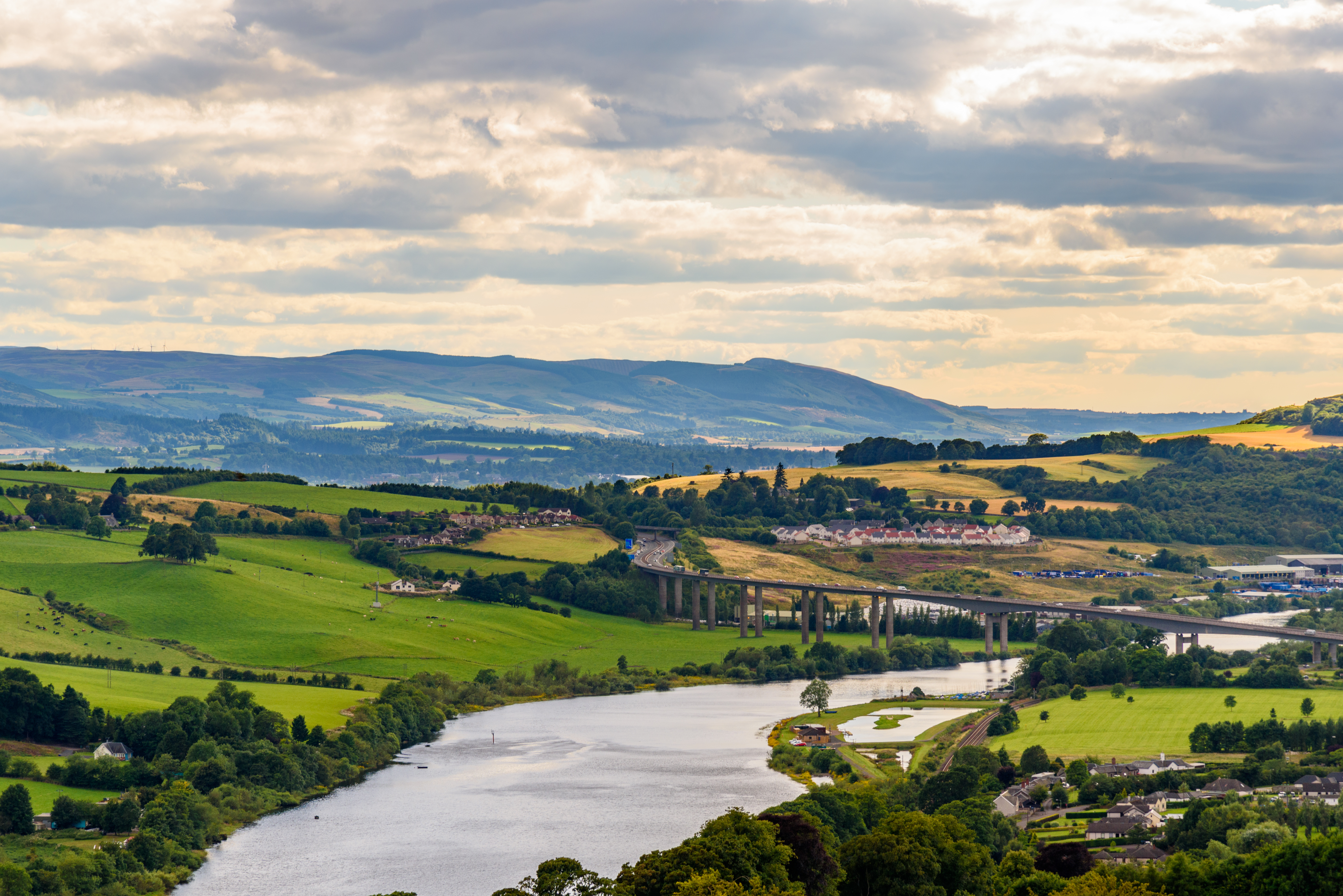 View of hills, fields, a large road and a wide river near Perth in Scotland