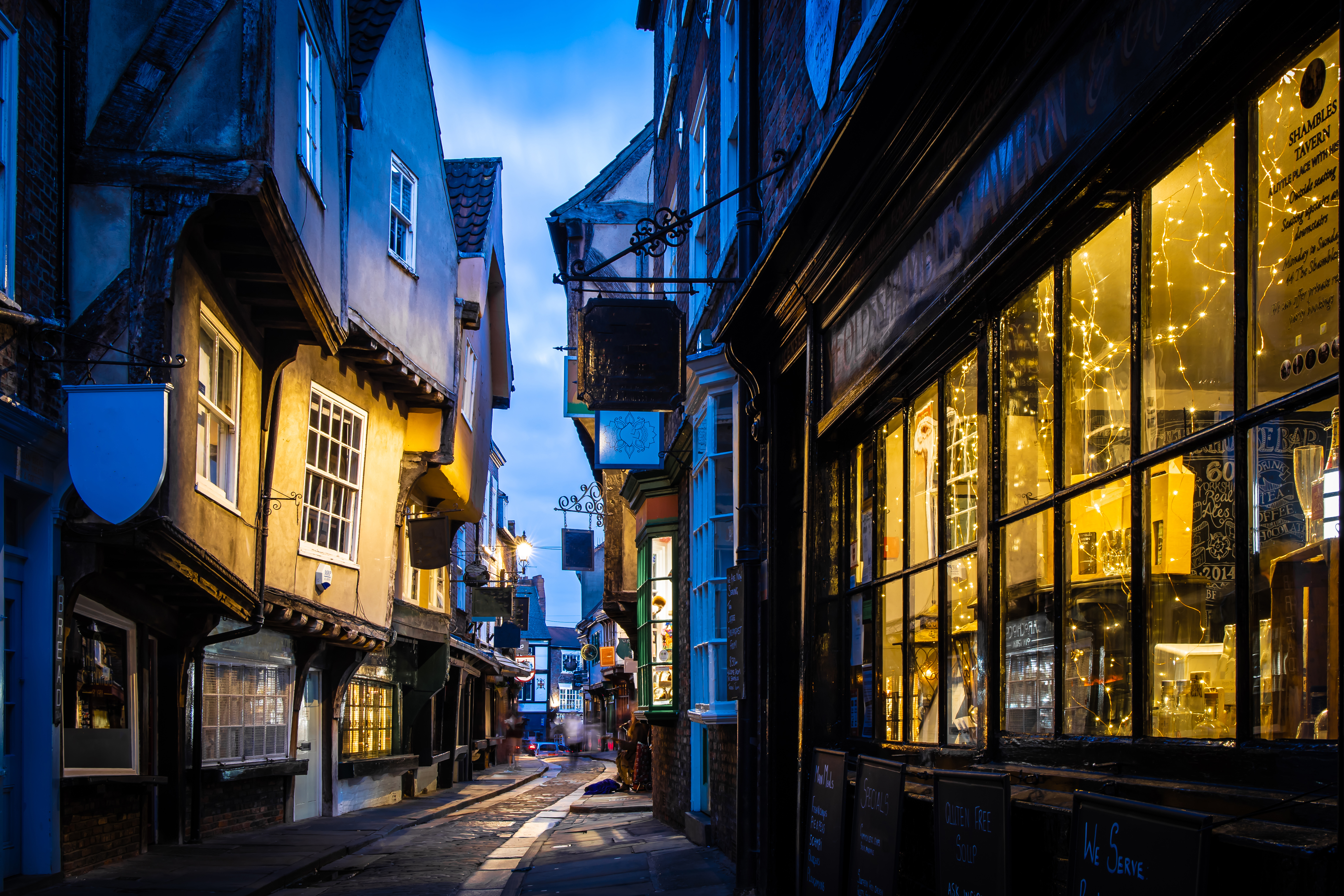 View down a narrow pedestrian thoroughfare in ancient York at dusk